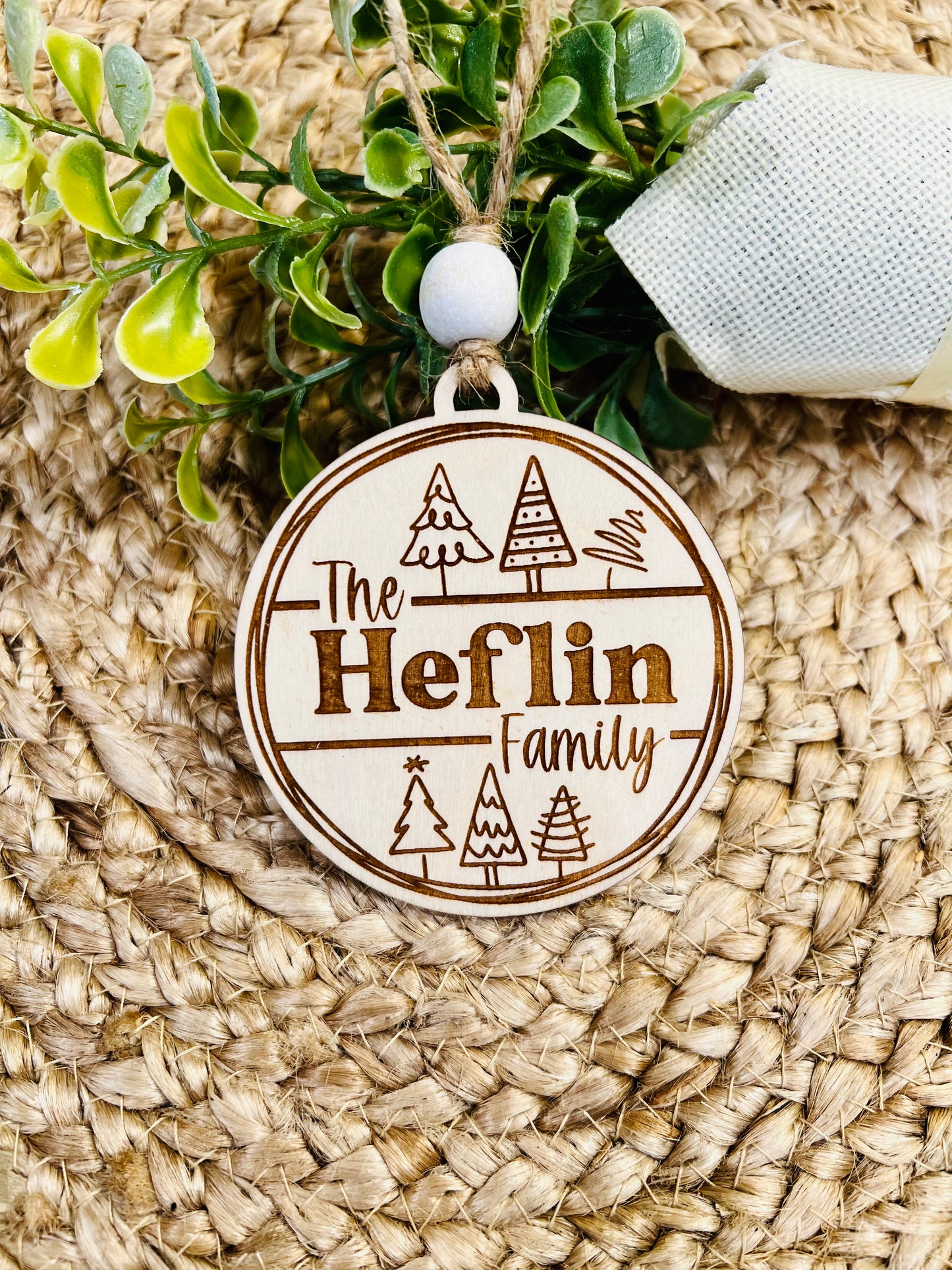 The ______ Family ornament with trees